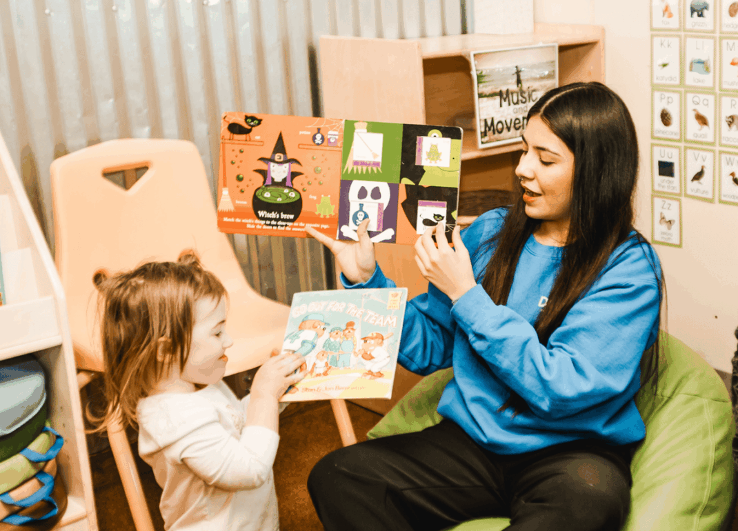 Woman reading to toddler.
